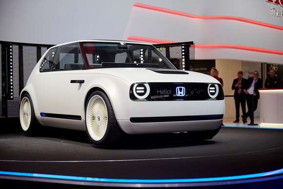 The Honda Urban EV Concept, a futuristic white hatchback, on Honda's auto-show stand.