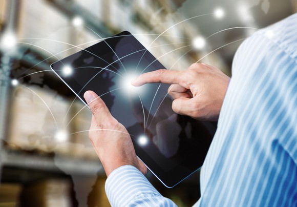 Person using software on a tablet in a warehouse