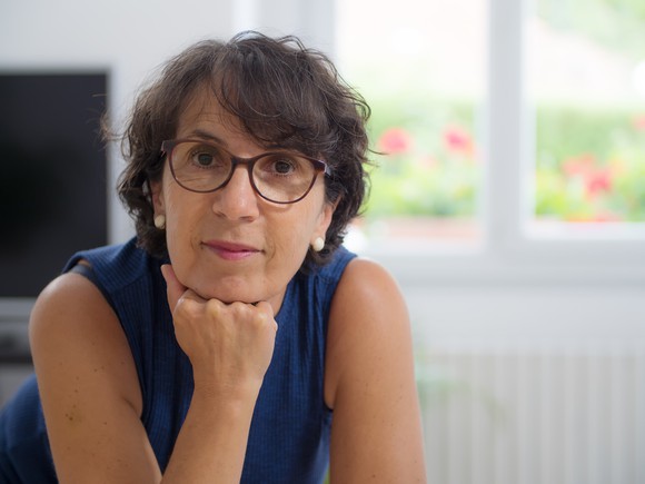 middle-aged woman in glasses looking directly at camera