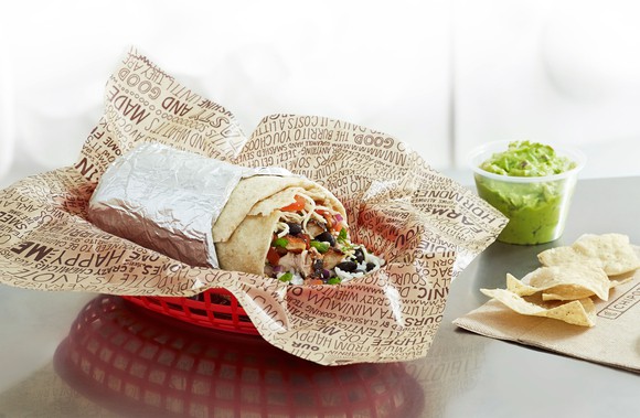 A Chipotle burrito, guacamole, and chips.