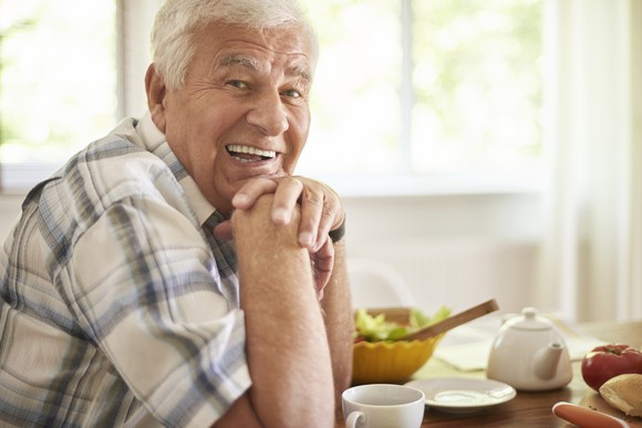 Smiling senior man in plaid shirt