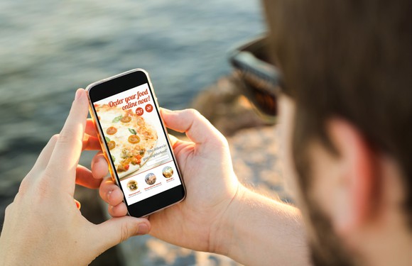 Man ordering pizza on his mobile phone