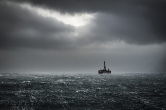 An offshore drilling rig in stormy weather.