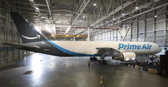 Amazon One, a company-owned airplane with the words "Prime Air" in large, sky-blue letter on the body.