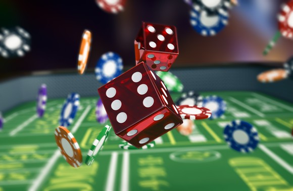 Chips and dice bouncing on a craps table.