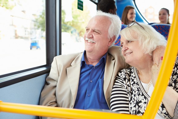 Senior couple looking out a bus window
