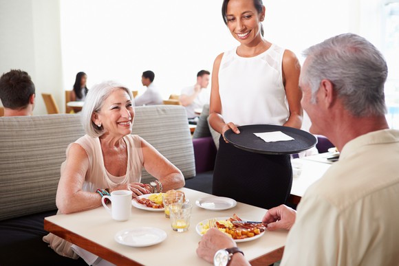Waitress tending to seniors at a restaurant