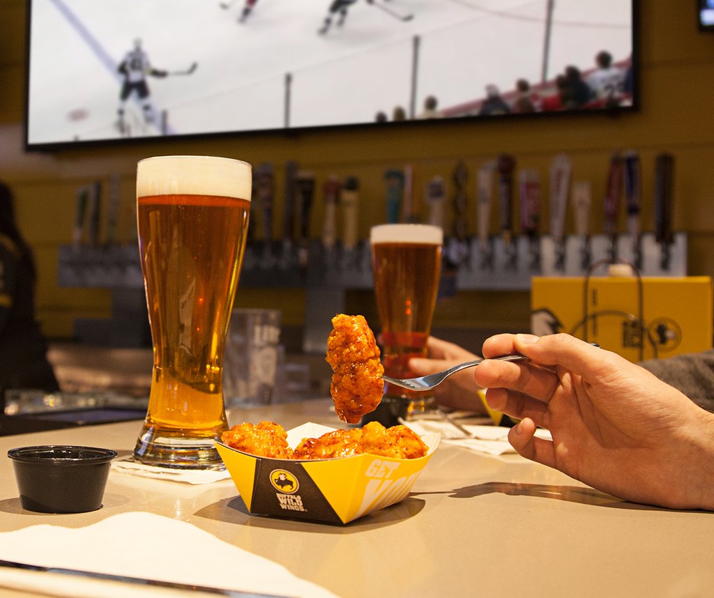 A customer eats boneless wings at a Buffalo Wild Wings.