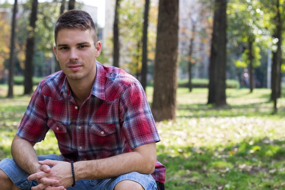 Smiling man in plaid shirt outdoors