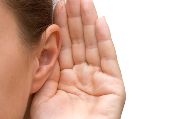 Person with hand cupped behind ear