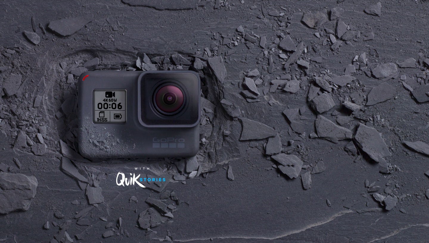 GoPro's HERO6 Black camera facing up on the ground surrounded by broken rocks