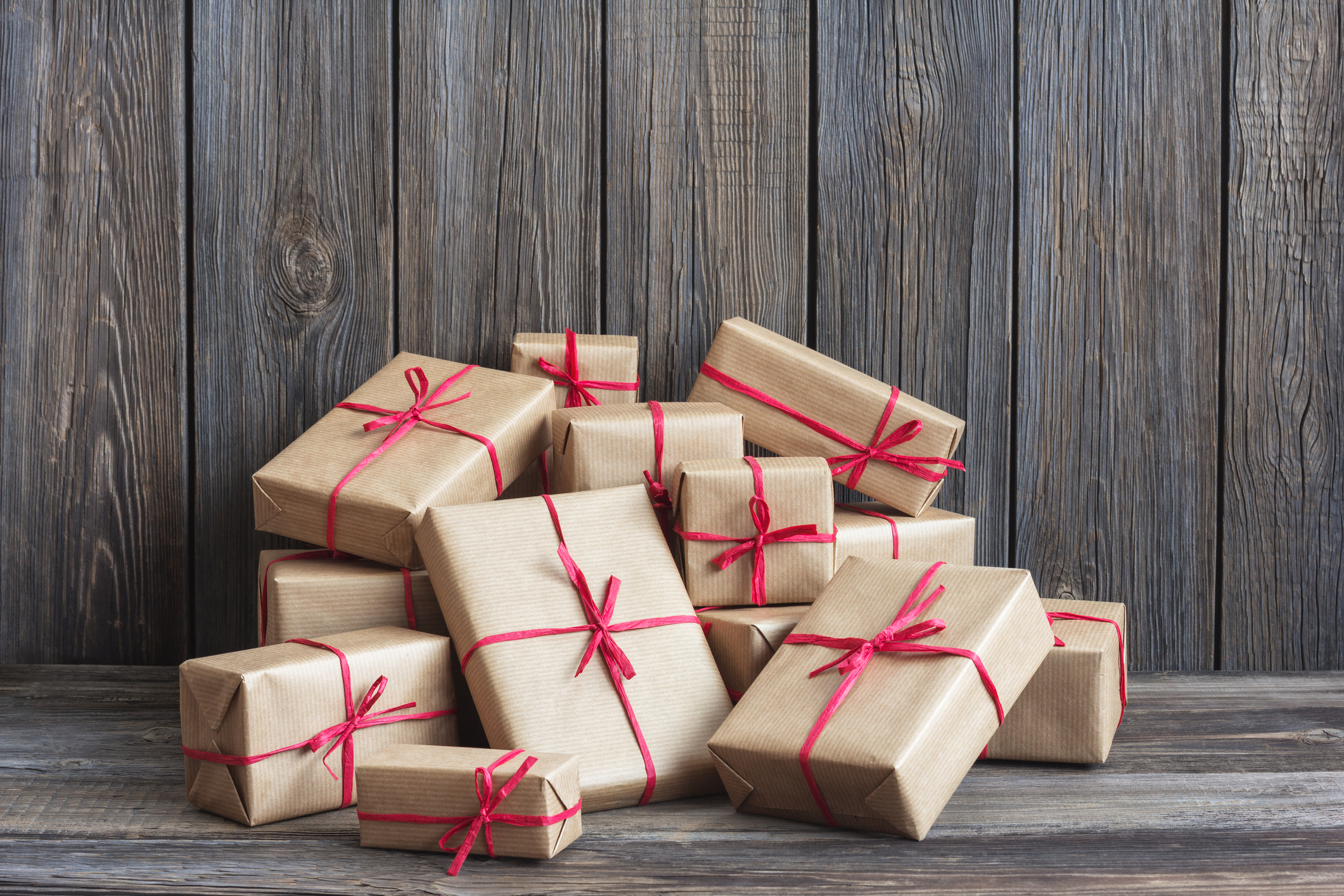 A pile of gift boxes tied with red ribbons.