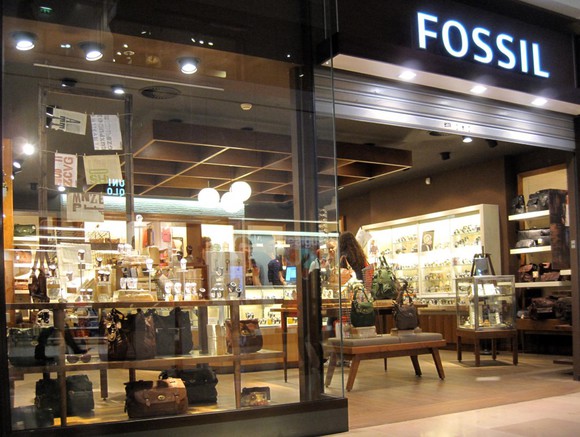 A Fossil retail location from outside the store looking in.