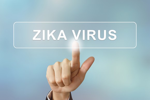 Finger pointing to screen with Zika virus displayed