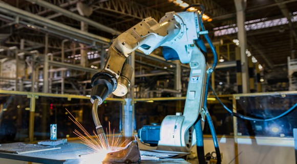 A robotic welding arm in a factory.