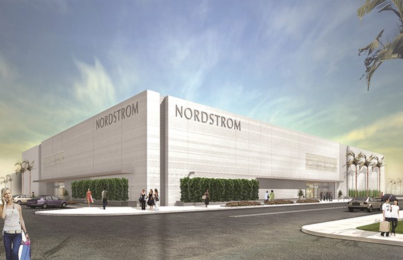White-marble Nordstrom store as seen from across a corner, with shoppers walking in and out carrying shopping bags.