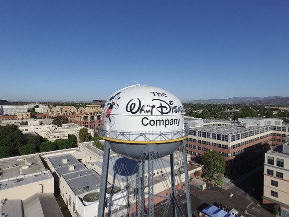A water tower with The Walt Disney Company and Mickey Mouse painted on it.