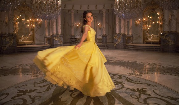 Emma Watson as Belle in a yellow gown in a ballroom for "Beauty and the Beast" movie.