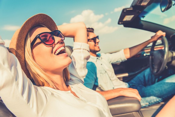 Photo of a couple in a convertible car.
