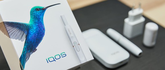 iQOS product package, including tobacco heating devices and accessories.