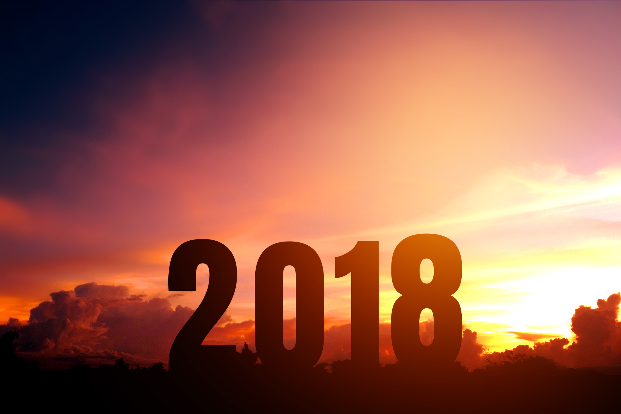 2018 in large numbers in front of setting sun.