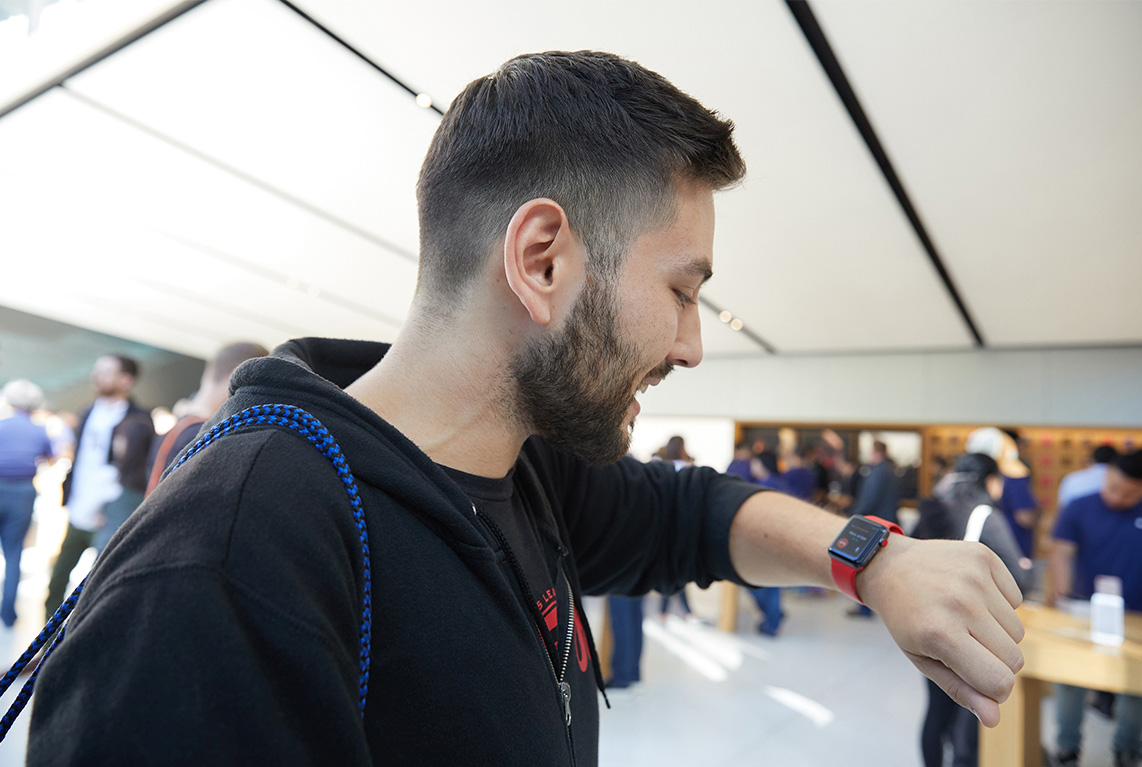 Customer looking at his Apple Watch Series 3 inside an Apple Store