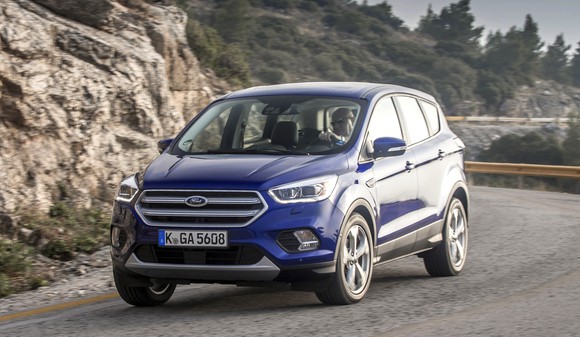A blue 2017 Ford Kuga, a compact SUV, on a mountain road.