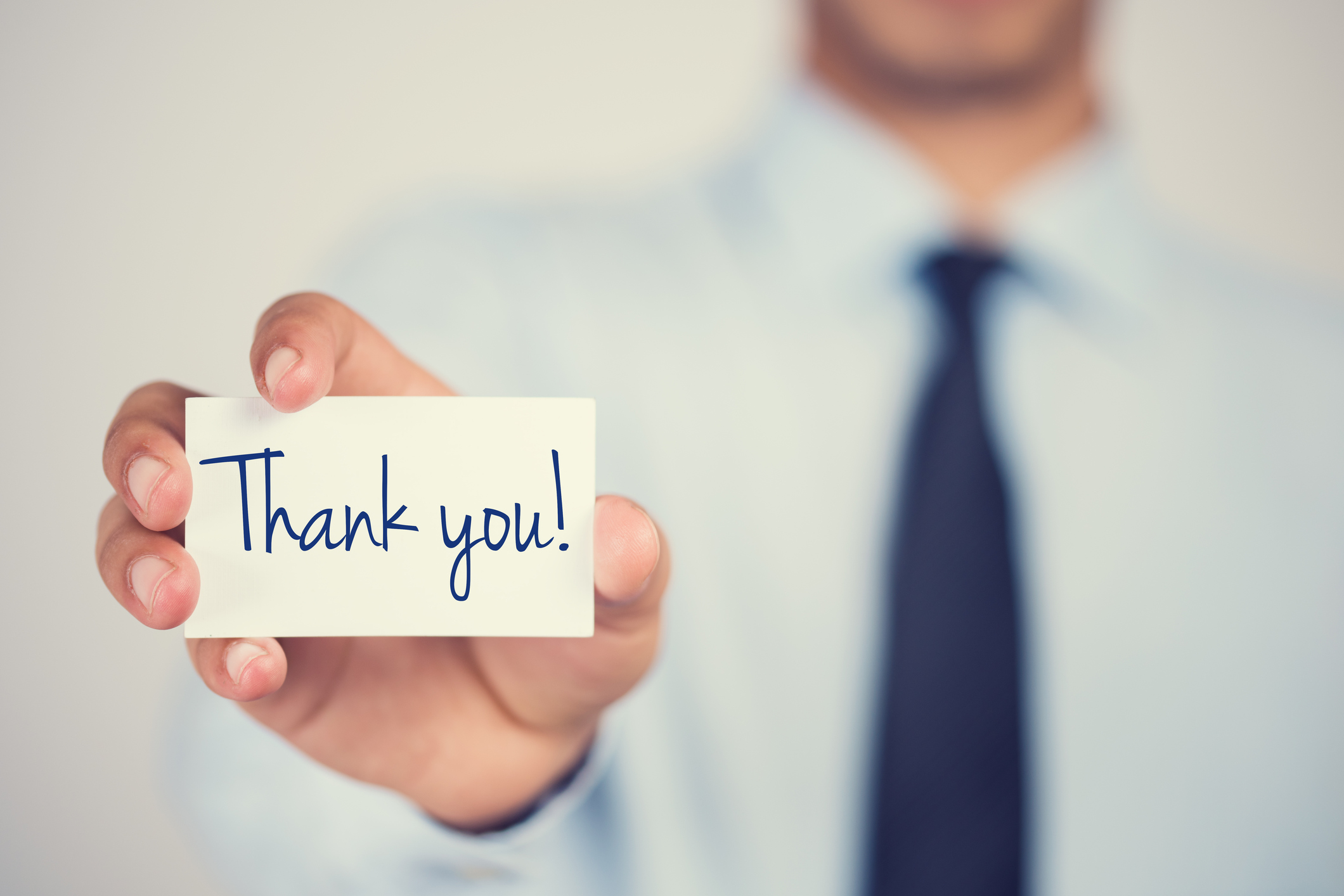 Person holding a thank-you card.