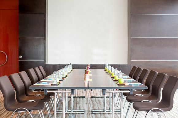 Empty contemporary conference room with wall-hung whiteboard