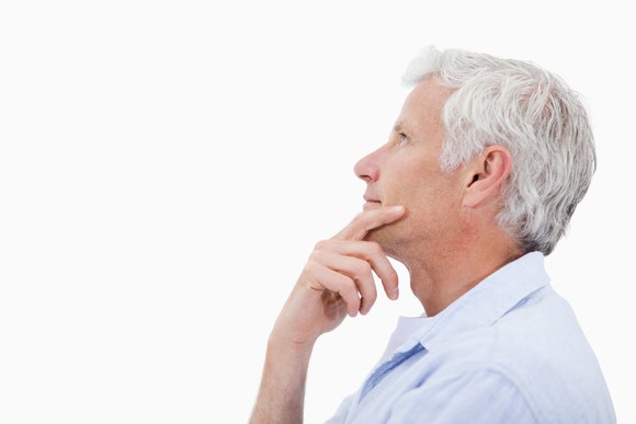 white-haired man thinking in profile