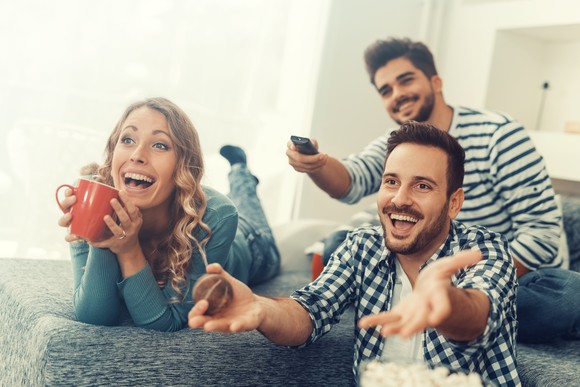 Family watching TV and laughing