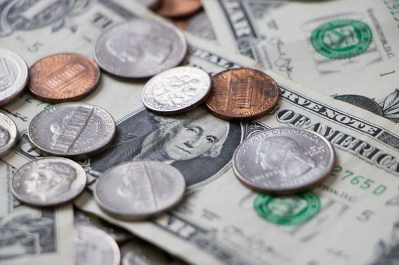 U.S. coins on top of $1 bills