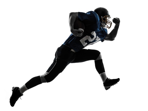 American football player in number 27 jersey running with the ball