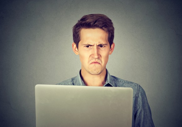 Man frowning at laptop