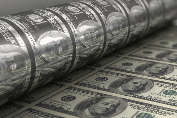 A roll of $100 bills coming off the printer.