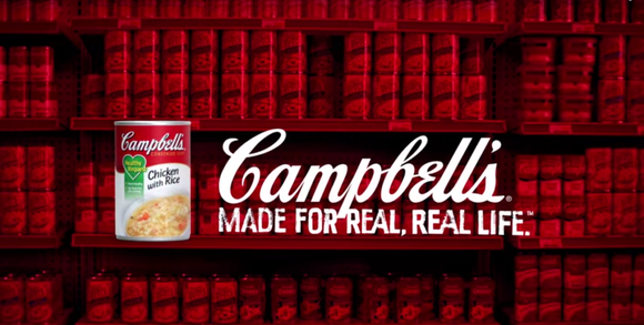 Bookshelf in background, can of Campbell Chicken with Rice in foreground with Campbell slogan.