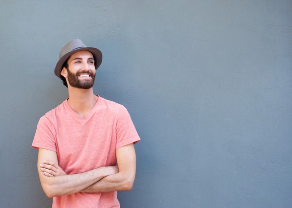 Smiling younger male in t-shirt and hat