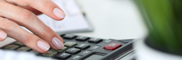Woman pressing buttons on a calculator
