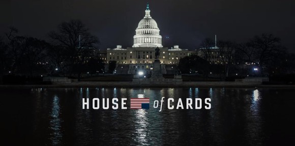The House of Cards logo in front of the U.S. Capitol building at night