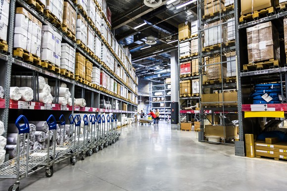 A warehouse with its shelves packed with goods