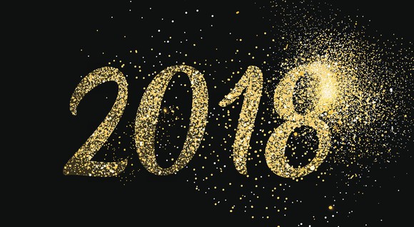 Numbers 2018 in gold on a black background with gold sparkles.