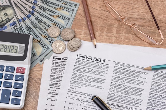 W-4 form for withholding, along with cash and a calculator with pencils and pens.