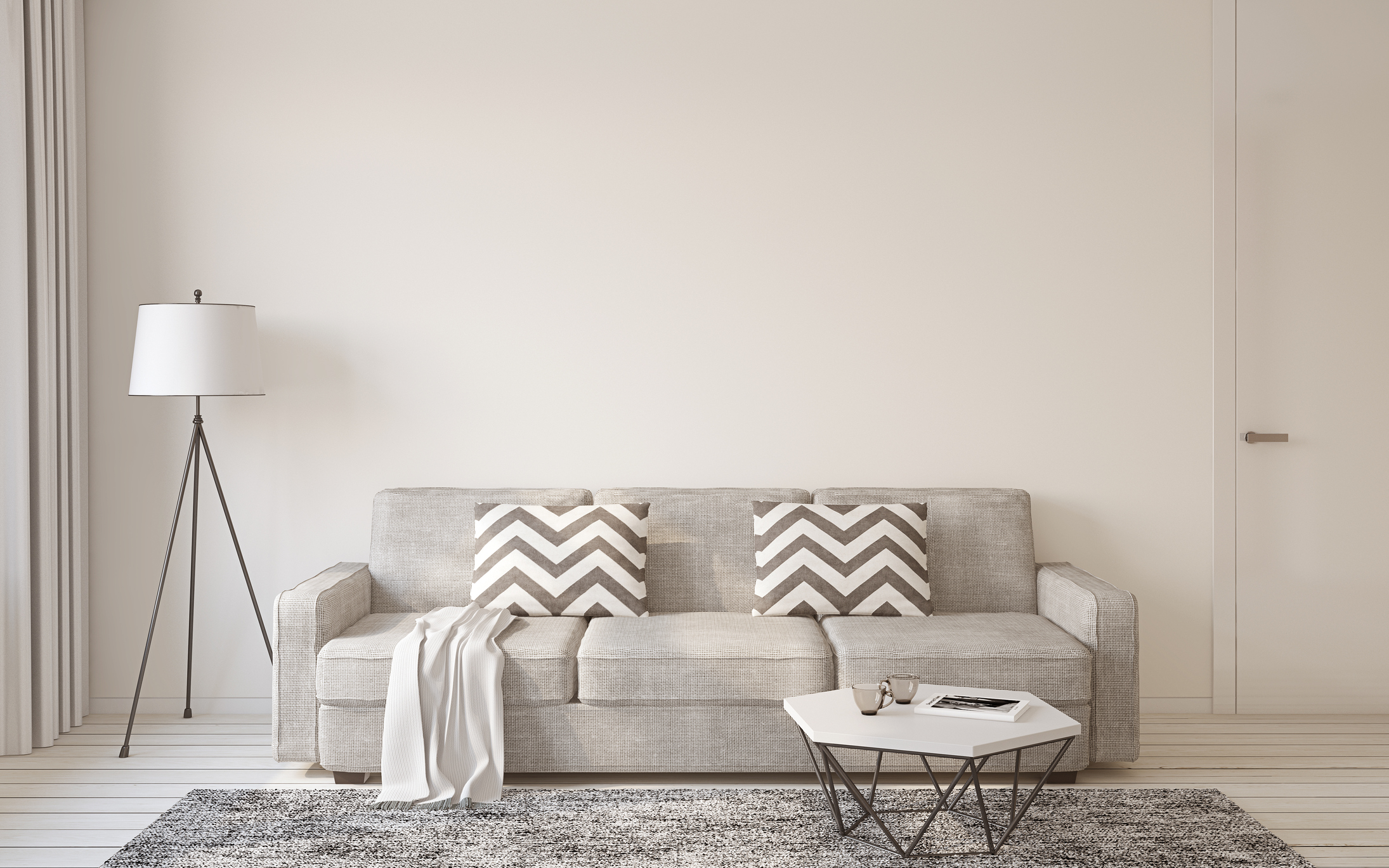 Lamp next to a tan couch and a small white table