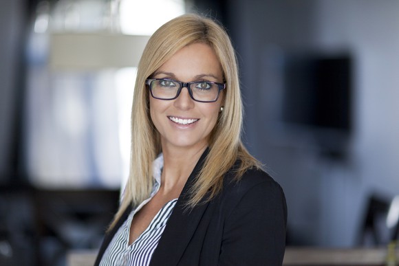 Professionally dressed woman smiling