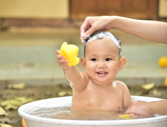 A baby having his hair washed.