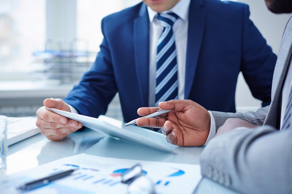 Two professionals reviewing documents at a table