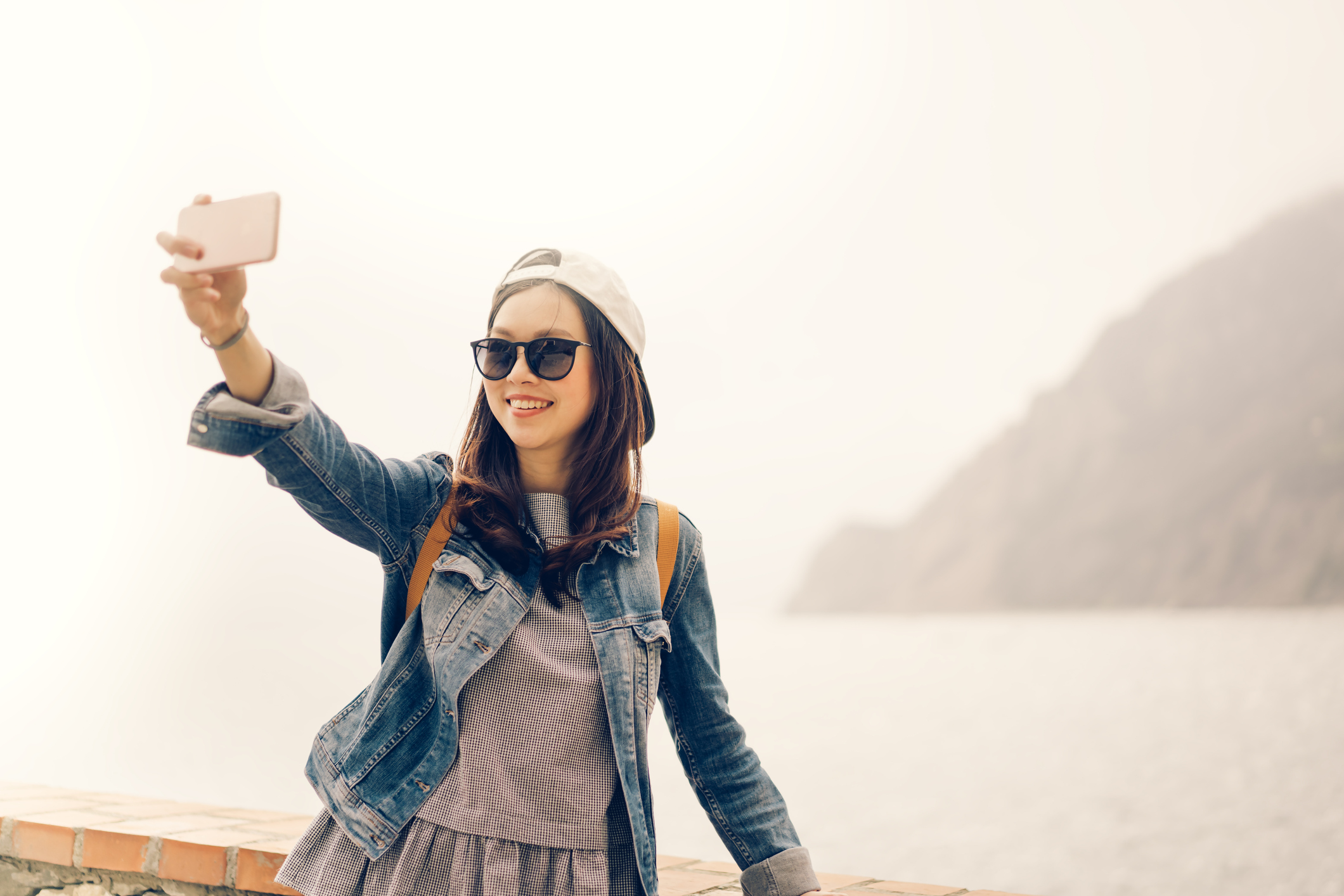A woman takes a selfie.