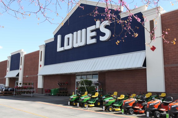 Lowe's storefront with riding lawnmowers in front.