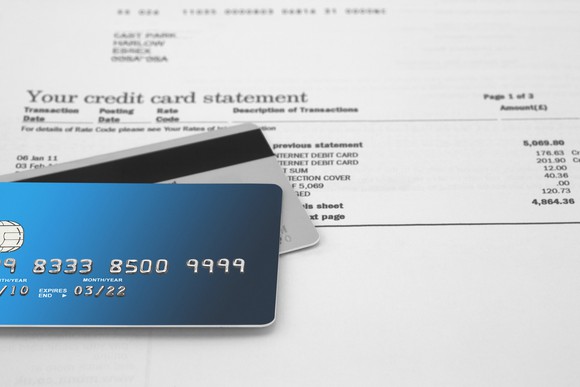 Credit cards resting on a credit card statement
