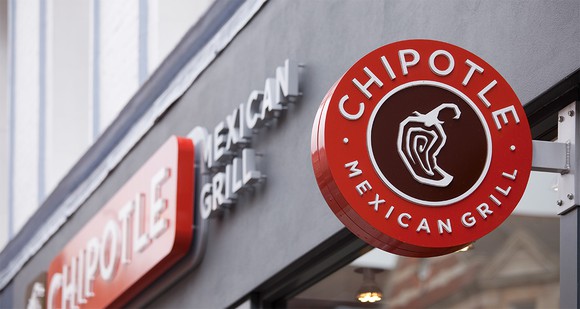 A Chipotle sign outside a restaurant.